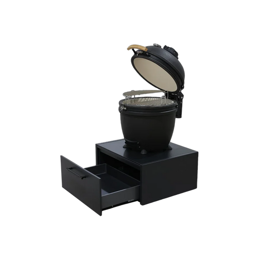 A black ceramic kamado-style grill with its lid open, sitting on a matching black storage base with one drawer pulled out, shown on a plain white background.