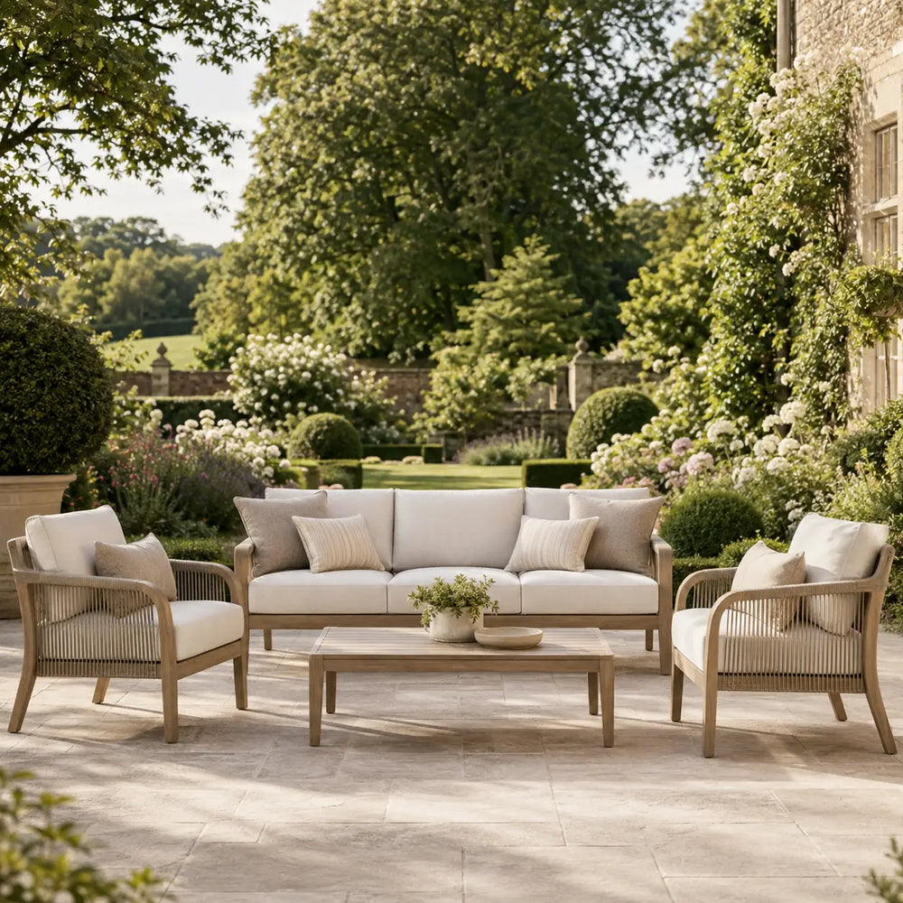 Luxury garden furniture set with cream cushioned sofa, matching armchairs and wooden coffee table on an elegant garden terrace – Verdant Lounge UK
