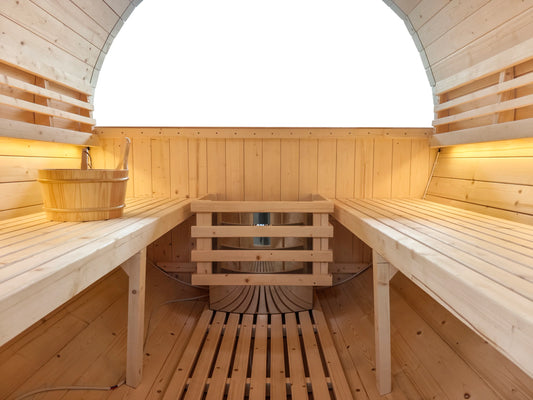 Interior of The Pennine Barrel 4 Person Sauna showing traditional timber benches and warm lighting – Verdant Lounge
