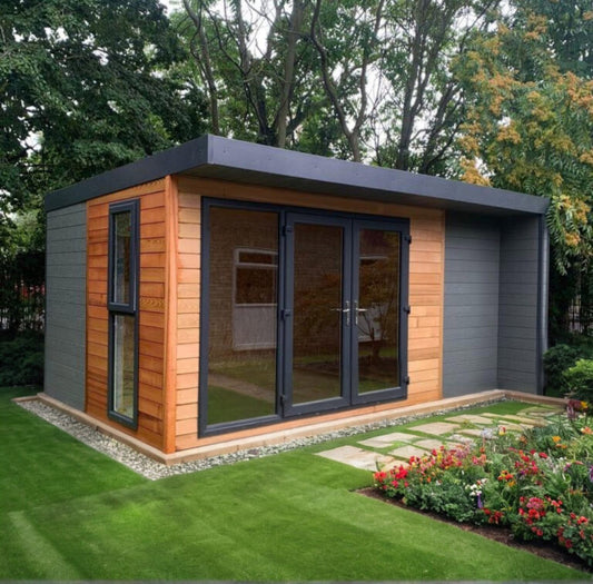Sanctuary Garden Office with flat roof, glazed entrance and contrasting grey and timber-effect cladding in a landscaped garden.