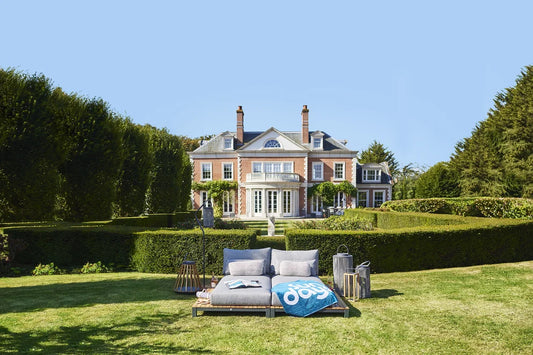 Evora Daybed luxury outdoor furniture in a landscaped garden